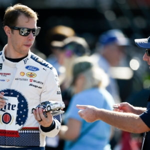 Monster Energy NASCAR Cup Series driver Brad Keselowski (2) autographs a fan's miniature car during practice for the Can-Am 500 at ISM Raceway.