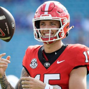 Georgia Bulldogs quarterback Carson Beck (15) warms up before a game against the Florida Gators at EverBank Stadium.