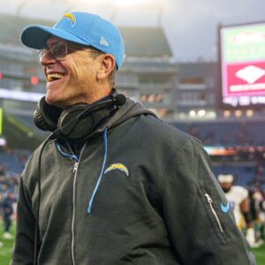 Los Angeles Chargers head coach Jim Harbaugh reacts after defeating the New England Patriots at Gillette Stadium.