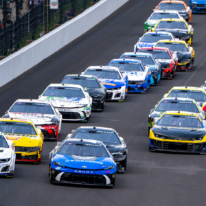 Cars race into turn one during a restart of the 30th running of the Brickyard 400, Sunday, July 21, 2024, at Indianapolis Motor Speedway.
