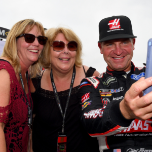 Monster Energy NASCAR Cup Series driver Clint Bowyer (right) poses for a selfie with fans during qualifying for the Alabama 500 at Talladega Superspeedway.