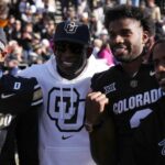 Colorado Buffaloes safety Shilo Sanders (21) and head coach Deion Sanders and quarterback Shedeur Sanders (2) and social media producer Deion Sanders Jr. following the win against the Oklahoma State Cowboys at Folsom Field.