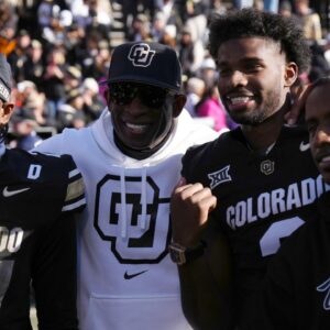 Colorado Buffaloes safety Shilo Sanders (21) and head coach Deion Sanders and quarterback Shedeur Sanders (2) and social media producer Deion Sanders Jr. following the win against the Oklahoma State Cowboys at Folsom Field.