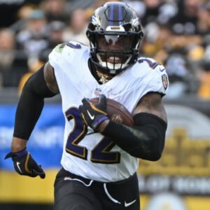 Nov 17, 2024; Pittsburgh, Pennsylvania, USA; Baltimore Ravens running back Derrick Henry (22) gains yardage while being chased by Pittsburgh Steelers linebacker T.J. Watt (90) during the second quarter at Acrisure Stadium.