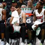 Miami Heat players (left to right) center Bam Adebayo (13), guard Tyler Herro (14), guard Terry Rozier (2) and forward Duncan Robinson (55) sit on the bench during the fourth quarter of their loss to the Boston Celtics at TD Garden.