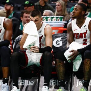 Miami Heat players (left to right) center Bam Adebayo (13), guard Tyler Herro (14), guard Terry Rozier (2) and forward Duncan Robinson (55) sit on the bench during the fourth quarter of their loss to the Boston Celtics at TD Garden.