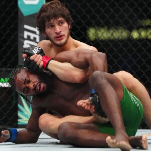 Movsar Evloev (red gloves) fights Aljamain Streling (blue gloves) at T-Mobile Arena.