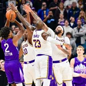 Utah Jazz guard Collin Sexton (2) gets blocked by Los Angeles Lakers forward LeBron James (23), forward/center Anthony Davis (3), and center Christian Koloko (10) in the final second of the second half at the Delta Center.