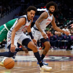 Washington Wizards guard Jordan Poole (13) dribbles the ball as Boston Celtics center Luke Kornet (40) defends in the third quarter at Capital One Arena.