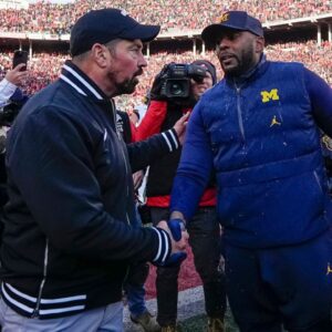 Ohio State Buckeyes head coach Ryan Day shakes hands with Michigan Wolverines head coach Sherrone Moore following the NCAA football game at Ohio Stadium in Columbus on Saturday, Nov. 30, 2024. Michigan won 13-10.