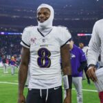 Baltimore Ravens quarterback Lamar Jackson (8) smiles while walking off the field after the game against the Houston Texans at NRG Stadium.