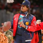 Former NFL quarterback Cam Newton on the court during a game between the Atlanta Hawks and Detroit Pistons in the second quarter at State Farm Arena.