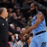 Los Angeles Clippers guard James Harden (1) is greeted by head coach Tyronn Lue during the first quarter against the Utah Jazz at Intuit Dome.