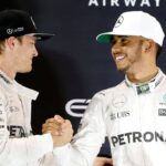Mercedes Formula One driver Nico Rosberg (L) of Germany shakes hands with Lewis Hamilton of Britain