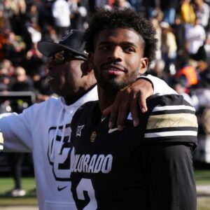 Colorado Buffaloes quarterback Shedeur Sanders (2) and head coach Deion Sanders ifollowing the win over the Oklahoma State Cowboys at Folsom Field.