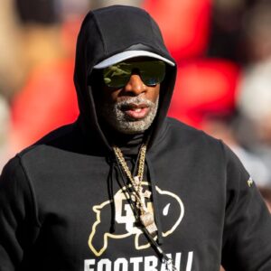 Colorado head coach Deion Sanders watches his players warmup prior to the game between the Kansas Jayhawks and the Colorado Buffaloes at GEHA Field at Arrowhead Stadium.