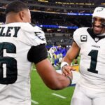 Nov 24, 2024; Inglewood, California, USA; Philadelphia Eagles quarterback Jalen Hurts (1) celebrates with running back Saquon Barkley (26) after the Eagles defeat the Los Angeles Rams during the first half at SoFi Stadium.