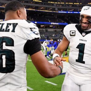 Nov 24, 2024; Inglewood, California, USA; Philadelphia Eagles quarterback Jalen Hurts (1) celebrates with running back Saquon Barkley (26) after the Eagles defeat the Los Angeles Rams during the first half at SoFi Stadium.