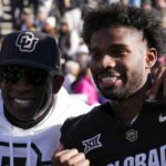 Nov 29, 2024; Boulder, Colorado, USA; Colorado Buffaloes safety Shilo Sanders (21) and head coach Deion Sanders and quarterback Shedeur Sanders (2) and social media producer Deion Sanders Jr. following the win against the Oklahoma State Cowboys at Folsom Field.