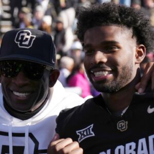Nov 29, 2024; Boulder, Colorado, USA; Colorado Buffaloes safety Shilo Sanders (21) and head coach Deion Sanders and quarterback Shedeur Sanders (2) and social media producer Deion Sanders Jr. following the win against the Oklahoma State Cowboys at Folsom Field.