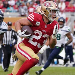 Nov 17, 2024; Santa Clara, California, USA; San Francisco 49ers running back Christian McCaffrey (23) rushes the ball while be pursued by Seattle Seahawks linebacker Derick Hall (58) in the fourth quarter at Levi's Stadium.