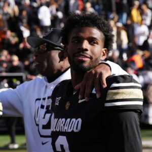 Colorado Buffaloes quarterback Shedeur Sanders (2) and head coach Deion Sanders ifollowing the win over the Oklahoma State Cowboys at Folsom Field.