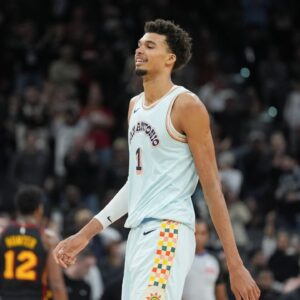 San Antonio Spurs center Victor Wembanyama (1) smiles in overtime against the Atlanta Hawks at Frost Bank Center.
