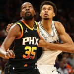 Phoenix Suns forward Kevin Durant (35) against San Antonio Spurs center Victor Wembanyama (1) in the first half of an NBA Cup game at Footprint Center.