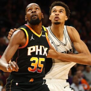 Phoenix Suns forward Kevin Durant (35) against San Antonio Spurs center Victor Wembanyama (1) in the first half of an NBA Cup game at Footprint Center.