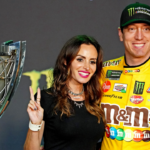 Nov 17, 2019; Homestead, FL, USA; NASCAR Cup Series driver Kyle Busch (18) celebrates after winning the NASCAR Series Cup Championship with his wife Samantha Busch after the Ford EcoBoost 400 at Homestead-Miami Speedway. Mandatory Credit: John David Mercer-Imagn Images