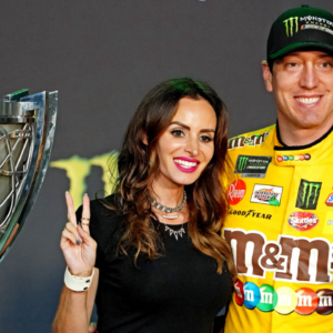 Nov 17, 2019; Homestead, FL, USA; NASCAR Cup Series driver Kyle Busch (18) celebrates after winning the NASCAR Series Cup Championship with his wife Samantha Busch after the Ford EcoBoost 400 at Homestead-Miami Speedway. Mandatory Credit: John David Mercer-Imagn Images