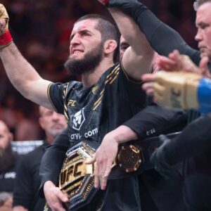 Islam Makhachev (red gloves) celebrates defeating Dustin Poirier (blue gloves) during UFC 302 at Prudential Center.