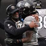Nov 16, 2024; Boulder, Colorado, USA; Colorado Buffaloes head coach Deion Sanders hugs wide receiver Travis Hunter (12) following a touchdown in the fourth quarter against the Utah Utes at Folsom Field.