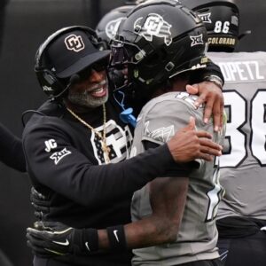 Nov 16, 2024; Boulder, Colorado, USA; Colorado Buffaloes head coach Deion Sanders hugs wide receiver Travis Hunter (12) following a touchdown in the fourth quarter against the Utah Utes at Folsom Field.