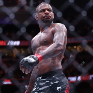 Michael Johnson (red gloves) reacts after defeating Ottman Azaitar (blue gloves) at Amalie Arena.