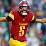 Washington Commanders quarterback Jayden Daniels (5) celebrates after throwing a touchdown during the fourth quarter against the Philadelphia Eagles at Northwest Stadium.