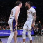 Los Angeles Lakers guard Austin Reaves (15) and guard D'Angelo Russell (1) react after a basket during the second half against the Brooklyn Nets at Barclays Center