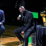 Basketball Hall of Fame and former Boston Celtic, Kevin Garnett speaks with Brian Scalabrine during the number retirement ceremony after the game between the Boston Celtics the Dallas Mavericks at TD Garden.