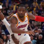 Golden State Warriors forward Jonathan Kuminga (00) dribbles by Minnesota Timberwolves forward Jaden McDaniels (3) in the fourth period at Chase Center