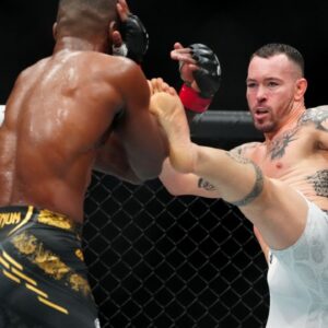 Leon Edwards (red gloves) fights Colby Covington (blue gloves) during UFC 296 at T-Mobile Arena.
