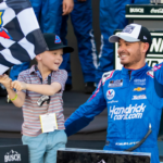 Nov 7, 2021; Avondale, Arizona, USA; NASCAR Cup Series driver Kyle Larson (5) celebrates with son Owen Larson after winning the 2021 NASCAR Cup Series Championship at Phoenix Raceway. Mandatory Credit: Mark J. Rebilas-Imagn Images