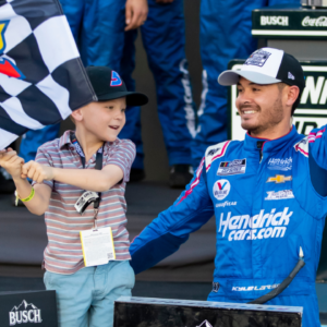 Nov 7, 2021; Avondale, Arizona, USA; NASCAR Cup Series driver Kyle Larson (5) celebrates with son Owen Larson after winning the 2021 NASCAR Cup Series Championship at Phoenix Raceway. Mandatory Credit: Mark J. Rebilas-Imagn Images