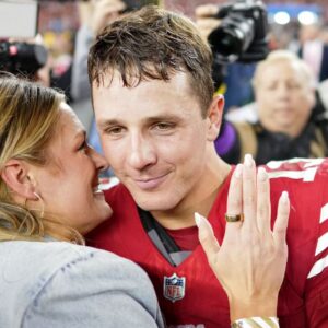 San Francisco 49ers quarterback Brock Purdy (13) kisses his fiance Jenna Brandt after winning the NFC Championship football game against the Detroit Lions at Levi's Stadium