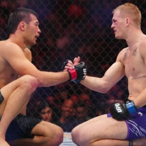 Shavkat Rakhmonov (red gloves) reacts with Ian Machado Garry (blues gloves) after their fight at T-Mobile Arena.