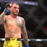 Renato Moicano (blue gloves) reacts after defeating Jalin Turner (not pictured) during UFC 300 at T-Mobile Arena.