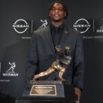 Miami Hurricanes quarterback Cam Ward poses for a photo during a press conference before the 2024 Heisman Trophy Presentation.
