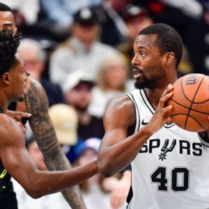 San Antonio Spurs forward Harrison Barnes (40) defends the ball against Utah Jazz guard Collin Sexton (2) during the first half at the Delta Center
