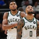 Milwaukee Bucks forward Giannis Antetokounmpo (34) and guard Damian Lillard (0) look on in the second quarter against the Chicago Bulls at Fiserv Forum.