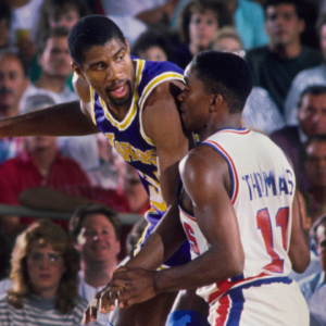 Los Angeles Lakers guard Magic Johnson (32) is defended by Detroit Pistons guard Isiah Thomas (11) at the Silverdome.