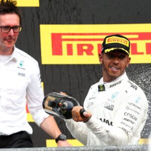 Mercedes Lewis Hamilton celebrates with champagne alongside Mercedes F1 Engineer Andrew Shovlin after victory in the 2017 Belgian Grand Prix
